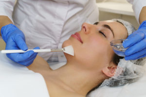 Cosmetologist applies moisturizing conductive gel before ultrasonic face cleaning procedure. Spa. Cleansing skin pores and deep moisturizing.