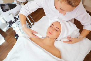 Woman on facial skincare procedure.
Hardware cosmetology.